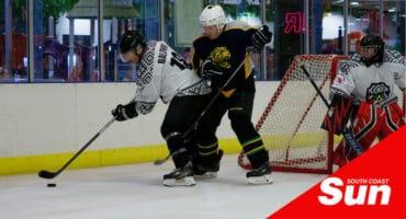 ice hockey players trying to get possession of the puck