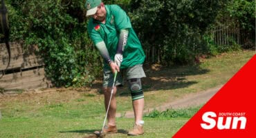 a man playing golf, about to tee off