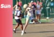 a netball player leaping off the ground in a court