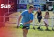 a rugby player practicing on the field, about to throw the ball