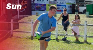 a rugby player practicing on the field, about to throw the ball