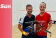 a duo of squash players in the court holding their racquets