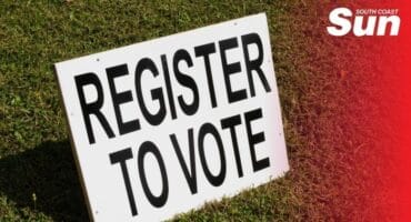 Register to vote board on grass