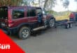 a vehicle being driven onto a tow truck