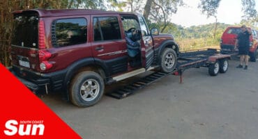 a vehicle being driven onto a tow truck