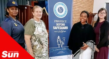 a group photograph in front of a banner