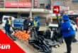 metro police confiscating a street hawker's stock of oranges with black bags