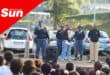 policemen speaking on stage at a school assembly