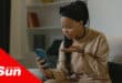 a woman gesturing with confusion at her cellphone
