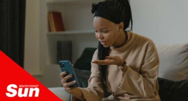 a woman gesturing with confusion at her cellphone