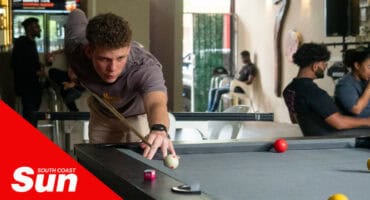 a pool player lining up a shot