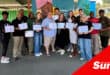 a group photograph of workshop attendees holding their certificates.