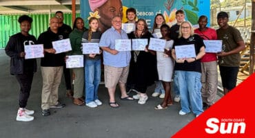 a group photograph of workshop attendees holding their certificates.