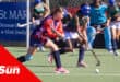 a schoolgirls' hockey tournament. a player moves in to score a goal