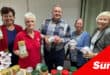 a group photograph with jars of food