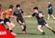 A Lancaster Grammar School player holds back Amanzimtoti's defensive line.
