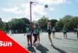 a netball tournament being played, with one player taking a shot