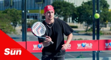 a person with a bandana playing padel