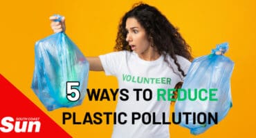 a woman holding two plastic bags