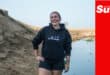 a portrait on the beach of a beach cleanup campaigner