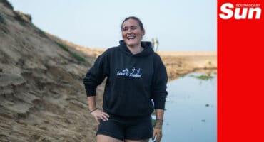 a portrait on the beach of a beach cleanup campaigner