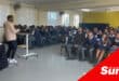 a classroom full of learners listening to a speaker in front of the class