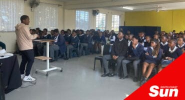 a classroom full of learners listening to a speaker in front of the class