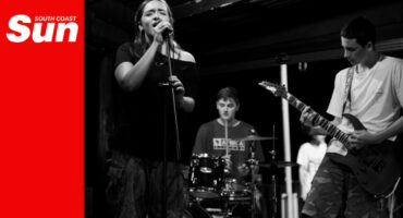 a teenage rock band performing on a small stage