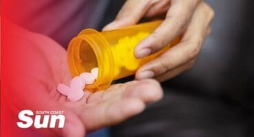 a pill bottle being emptied into someone's hands