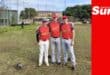 a group photograph of three baseball players on a field
