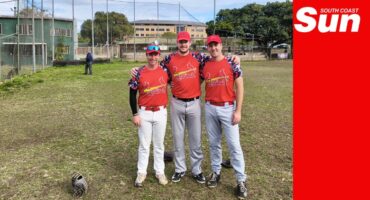 a group photograph of three baseball players on a field