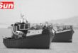 a photograph of multiple boats at a dock, taken in black and white