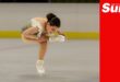 a figure skater performs a sit spin on ice