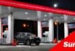 a van at a petrol station in the night