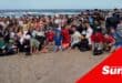 a large group photograph on a beach