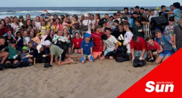 a large group photograph on a beach