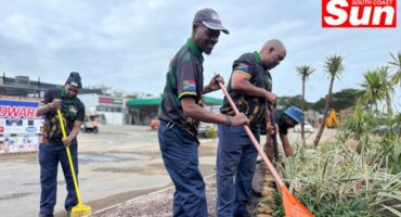 two men use rakes to brighten up and beautify a garden