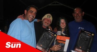 a group of fisherfolk show off their prizes after a competition