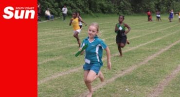 a track runner schoolchild competes in the relay race