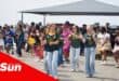 a group of children in heritage day attire dance to a song in unison