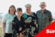 a group of pensioners show a gift voucher for Christmas