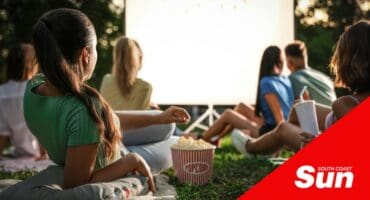 an outdoor movie night with popcorn and blankets