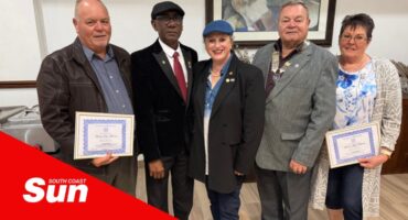 a group photograph with two people receiving certificates