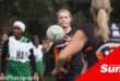 a netball player passes the ball to her teammate