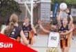 on a netball court, a defender passes the ball to an attacker