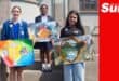 a group photograph of young artists showing their peace posters