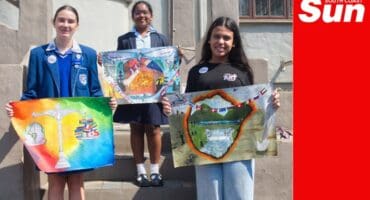 a group photograph of young artists showing their peace posters