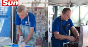 one man cutting buns and the other cracking an egg on a grill