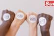 closed fists with vote stickers on them, different ethnicities
