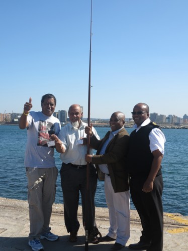 Desmond D'sa and Essop Mohamed of KZNSFF with port manager, Thami Ntshingila and harbour master, Captain Dennis Mqadi.